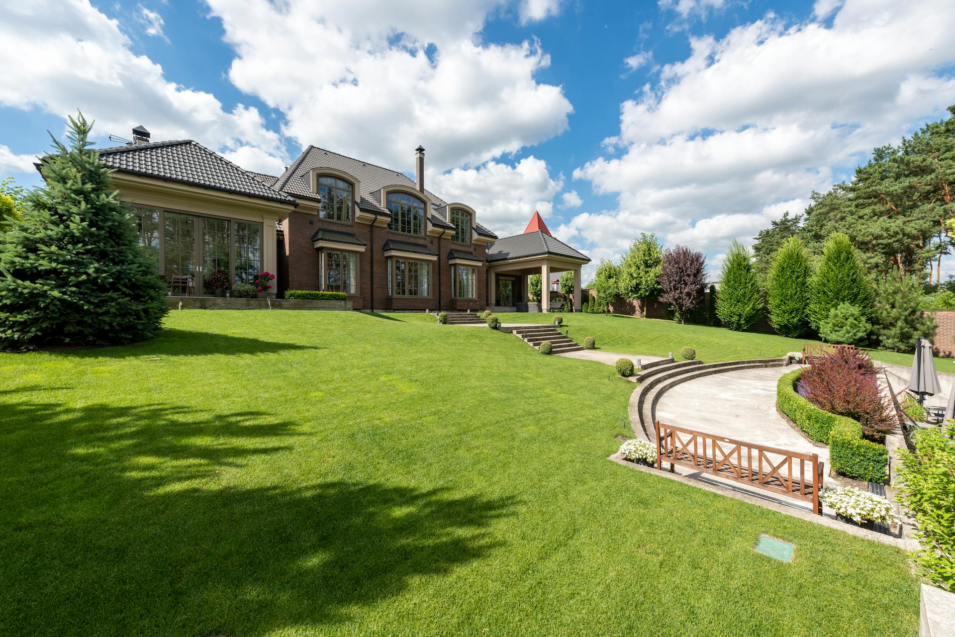 Lush manicured lawn in front of a luxury estate — professional lawn care and landscaping in Jefferson City, MO